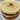 Carrot cake with white frosting on a clear glass plate