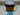 Chocolate cake on a blue stand with a blurred background