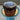 Chocolate cake with white icing on a blue stand