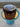 Chocolate cake with white icing on a blue stand