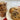 Chocolate chip cookies on a plate and in a clear plastic bag on a white surface.
