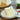 Slice of layered cake on a plate with a heart-themed napkin in the background