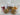 Three packaged cookies with ribbons and personalized tags on a marble surface