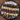Assorted chocolate and white square desserts on a black plate with a wooden background