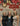Three women posing together in front of a Misericordia backdrop with '2026' balloons.