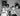 Black and white photo of a woman with three children