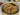 Chocolate chip cookies in a round container with a festive background