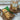 Irish soda bread with slices on a wooden board and whole loaves in packaging on a stand.