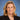 Woman with blonde hair wearing a dark blazer