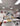 Group of people in a kitchen with trays of food.