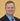 Man wearing a suit and tie with a yellow background