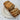 Loaf of raisin bread sliced on a white plate with a light gray textured background