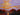 Card with a painting of a sunset over an autumn forest. 