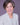 Woman wearing a light gray blazer against a purple background