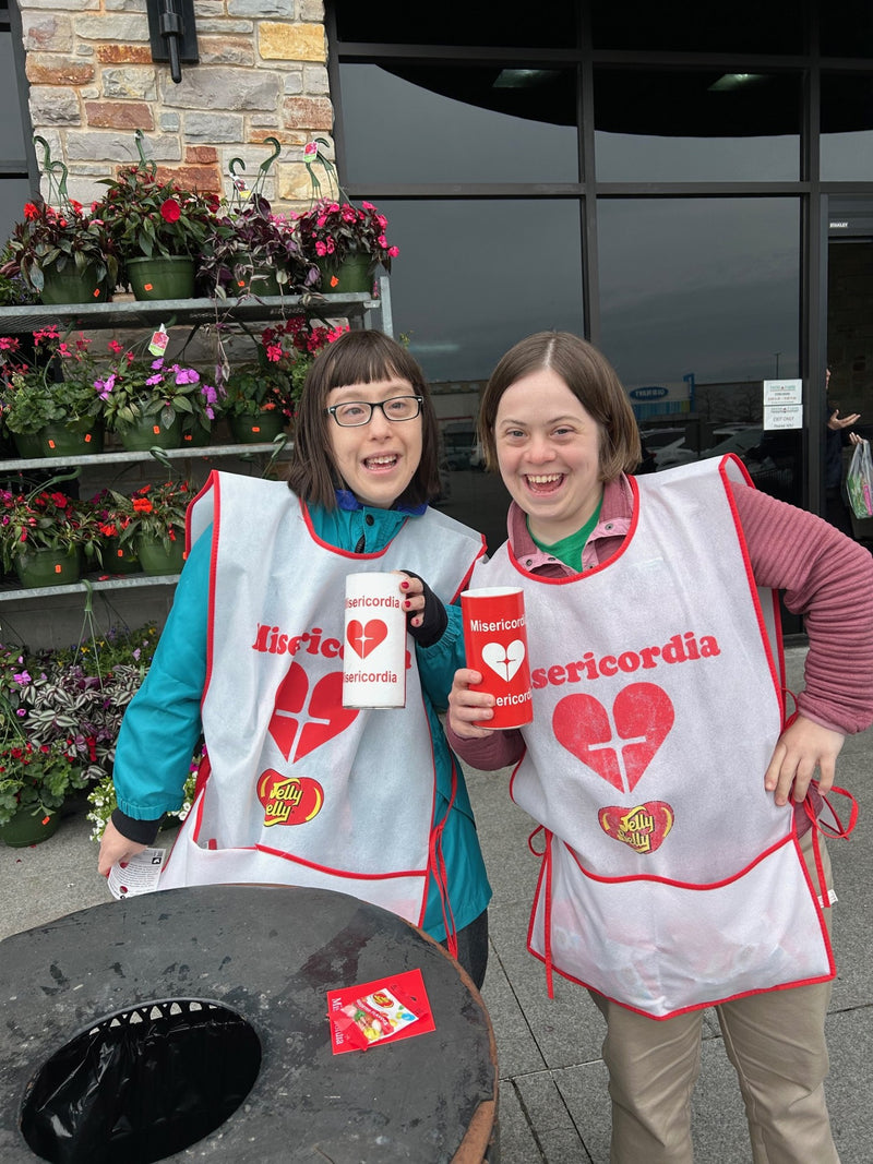 Two people Misericordia aprons posing for Candy Days. 