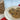 Oatmeal raisin cookies on a white plate with a clear bag of more cookies in the background.