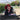 Person wearing a red hat and glasses, sitting outdoors with a happy expression.