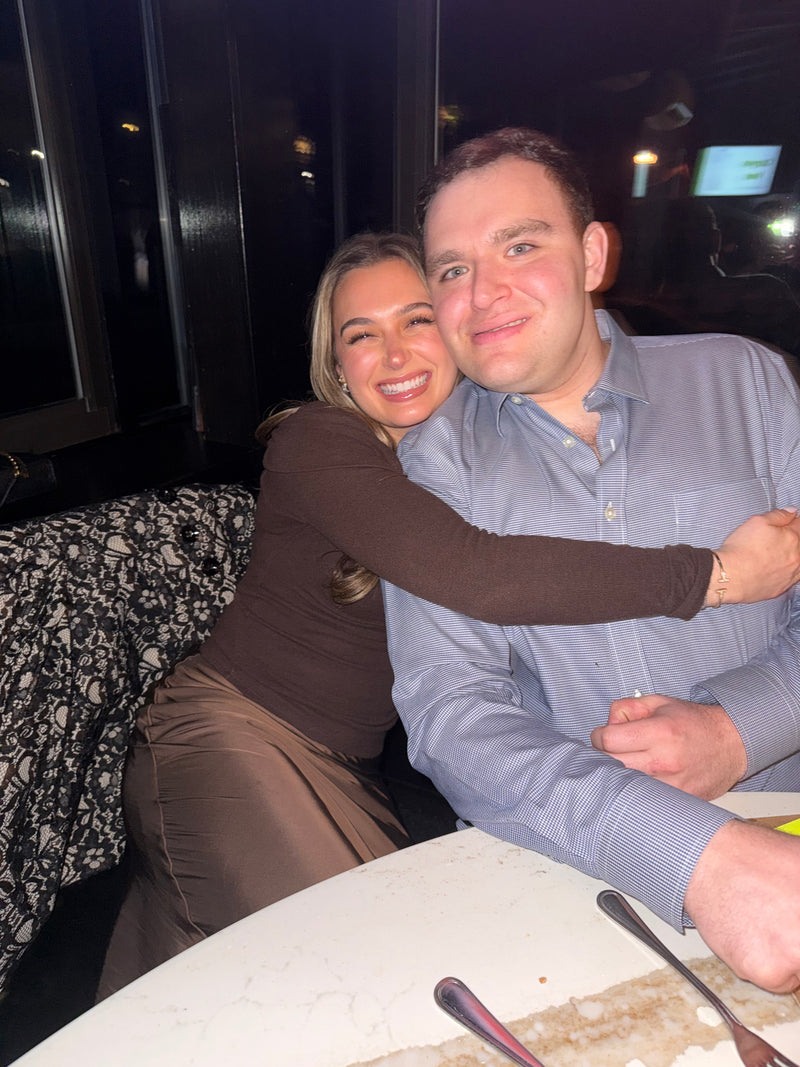 Two people posing for a photo in a casual setting