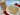 Cookies on a white plate with a clear plastic bag of cookies in the background.