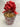 Bouquet of popcorn in a decorative paper cone with a red bow on a tiled wall background