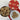 Cookies in a metal tin and on a plate with a heart-patterned lid on a wooden surface
