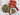 Cookies in a metal tin and on a plate with a heart-patterned lid on a wooden surface