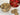 Cookies in a gold tin and on a white plate with a heart-themed container in the background.